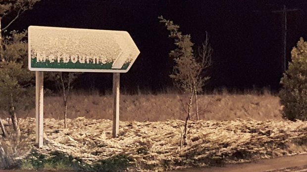 Snow-covered Melbourne sign on the Calder Freeway at Woodend.