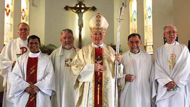 Bishop Les Tomlinson (fourth from left) with Father Joe Doyle (far right), photographed more than five years after the Melbourne Response ordered Fr Doyle to stop acting as a priest.