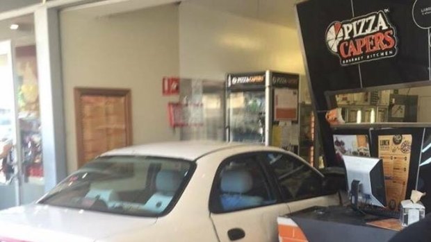 A car crashed through the front window of the Pizza Capers store at Strathpine.