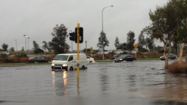 Motorists negotiate a flooded intersection at Cedric Street in Stirling. 