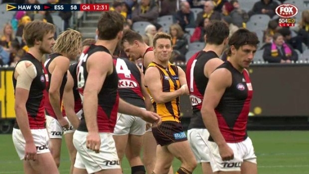Sam Mitchell taunts Essendon players, by feigning giving himself an injection.