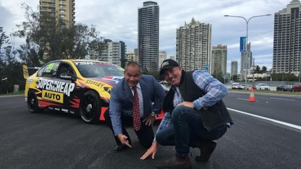 The new "super-bitumen" mix for the Gold Coast V8 Supercar track is inspected by Gold Coast mayor Tom Tate and driver Paul Morris.