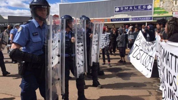 Riot police come face to face with protesters in Kalgoorlie.