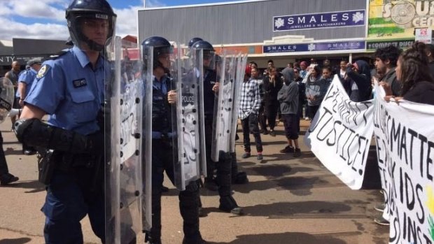 Riot police come face to face with protesters in Kalgoorlie.