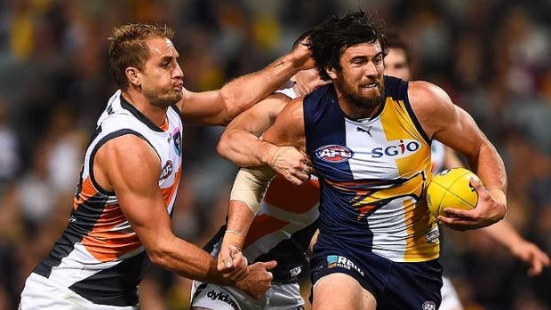 Josh Kennedy fends off GWS' Joel Patfull before the injury occurred