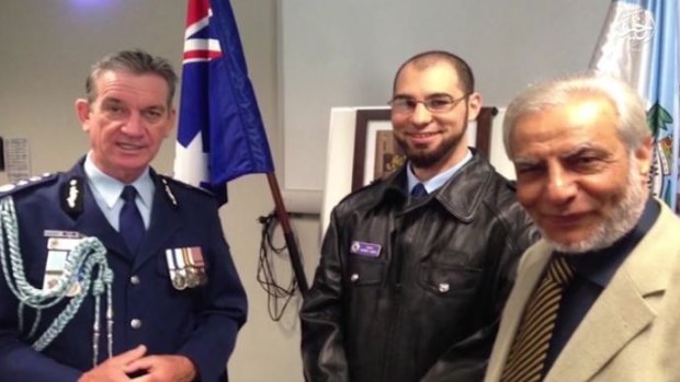 Police chaplain Sheikh Ahmed Abdo (centre) features in the Islamic State video alongside Police Commissioner Andrew Scipione and the Grand Mufti, Dr Ibrahim Abu Mohamed.