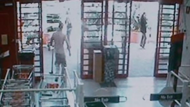 CCTV footage from Bunnings Warehouse shows a man leaving with a mattock in his left hand. 