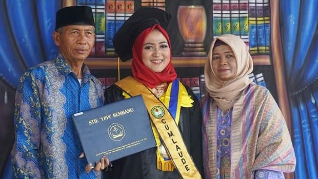 'What's wrong with your daughter?': Sanita Rini with her parents on graduation day. They had pressed her to marry when she was 13.