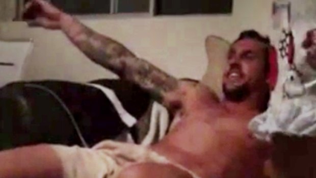 Damning: A still from the video showing a seemingly intoxicated Mitchell Pearce slumped in a chair