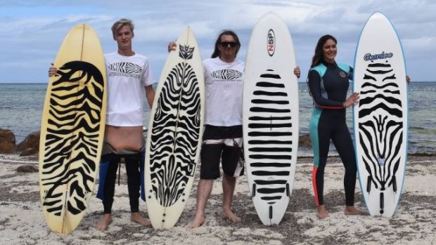 Mark Knight, Matt Cole and Jessica Gosnay with the different surfboard designs which they believe will deter sharks.