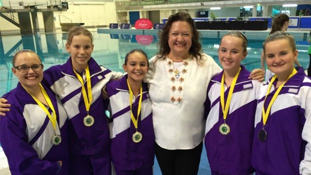 Precious medals: Gina Rinehart celebrates with synchronised swimmers.