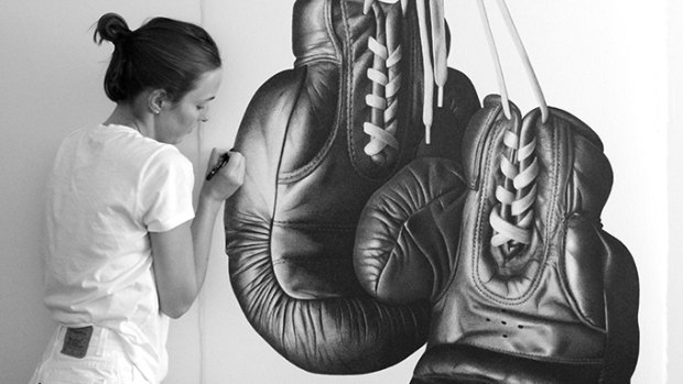 CJ Hendry puts the finishes touches to a pair of boxing gloves that attracted the attention of world champion pugilist Floyd Mayweather.