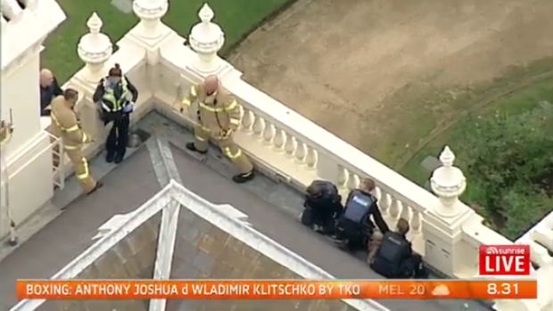 Authorities restrained the man on the roof of Government House.