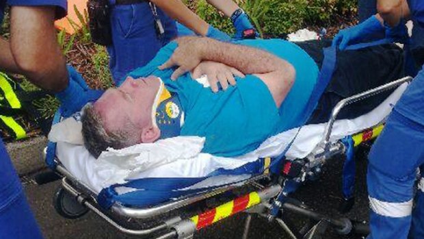 Paramedics treat Ryde mayor Bill Pickering after he was punched at Putney Public School.