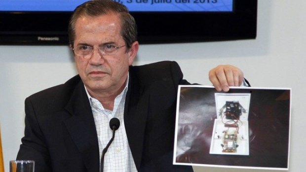 Ecuador's Foreign Minister Ricardo Patino shows a picture of a hidden spy microphone uncovered at the office of Ana Alban, the Ecuadorean ambassador to the United Kingdom.