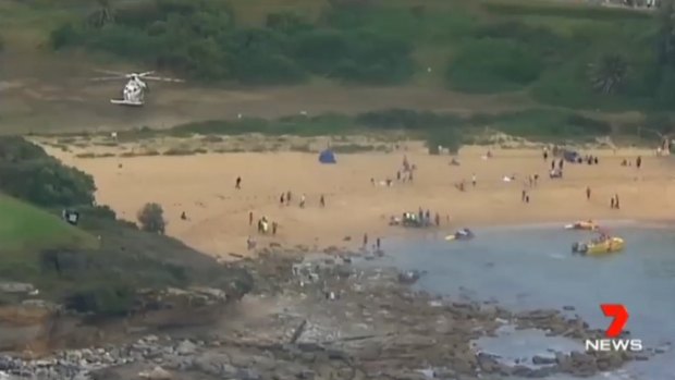 A fisherman is in a critical condition after being swept off rocks at Little Bay.