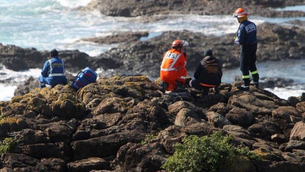 Emergency services search for a rock fisherman on Friday.