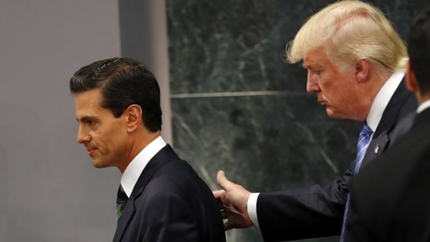 Republican presidential nominee Donald Trump walks with Mexican President Enrique Pena Nieto at the end of their joint statement in Mexico City.