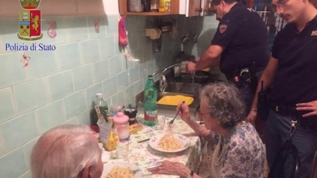 Police prepare pasta for an elderly Roman couple.