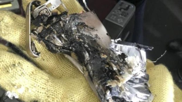 The remains of the phone which started smoking after being "crushed" in a seat mechanism.