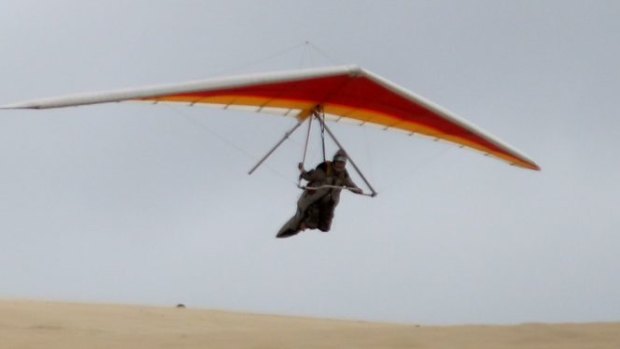 A hang glider takes off from the Great Dune of Pyla near the town of Arcachon, France.