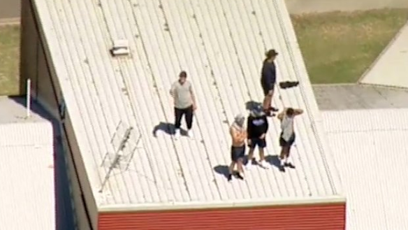 Youths on the roof of the Malmsbury Justice Centre.