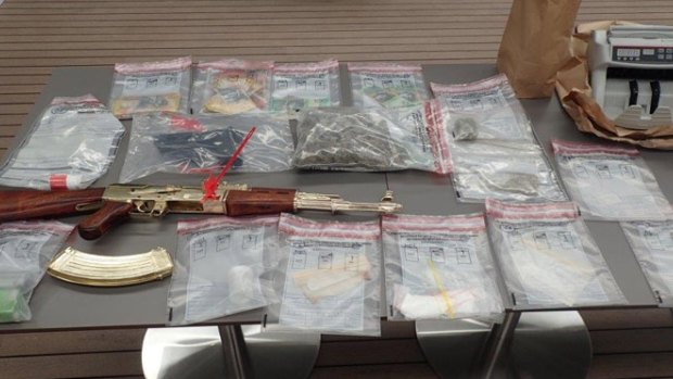 The replica AK47, drugs and cash were among the items seized.