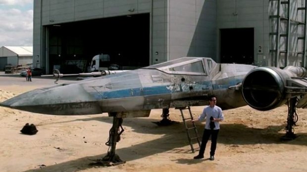 JJ Abrams stands in front of a starfighter built for his <i>Star Wars: The Force Awakens</i>.