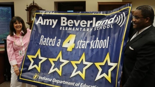 Susan Jordan unveiling a banner commemorating the school's rating by the Indiana Department of Education.