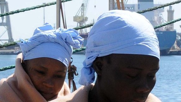 Asylum-seekers arrive in Palermo, Sicily, last week. In the background is the King Jacob Portuguese cargo vessel, the first ship to arrive near a boat believed to be crowded with 700 migrant in distress, only to see it capsizing in the waters north of Libya on Sunday.
