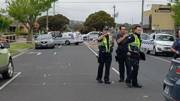 Police near the scene where a police officer opened fire on a man in Dandenong on Wednesday. 