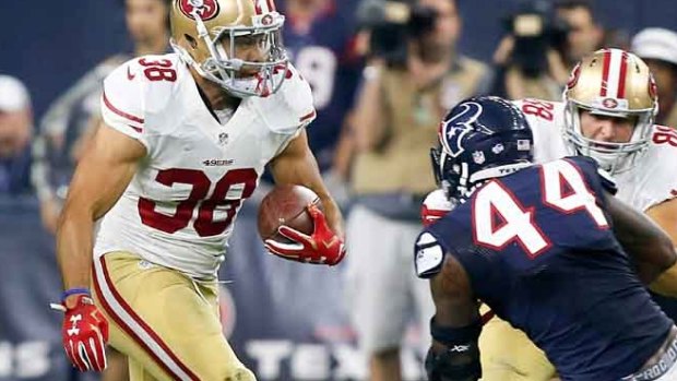 Fearless: Jarryd Hayne rushes past Carlos Thompson of the Houston Texans.