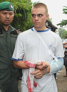 Tyler Gerard, 21, is escorted by police in Pattaya to re-enact the kidnapping and murder of Australian Hells Angels biker Wayne Schneider on Friday.