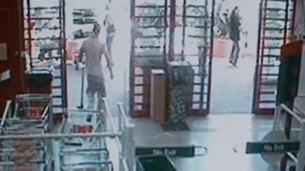 CCTV footage from Bunnings Warehouse shows a man leaving with a mattock in his left hand. 