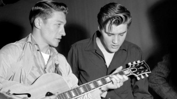 Scotty Moore and Elvis Presley rehearse for their appearance on the Milton Berle Show at the NBC Burbank studios on June 4, 1956, in Los Angeles.
