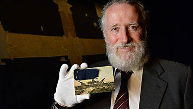 Adrian Millane pictured earlier with the fragment of the Southern Cross flag he put to auction with Mossgreen.