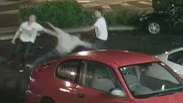 One man punches another man to the ground the Condor McDonalds car park.