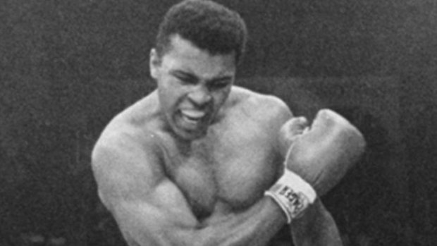 Muhammad Ali stands over fallen challenger Sonny Liston.