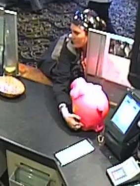 Police are appealing to the public to identify a woman who was caught on CCTV stealing a children's charity tin.