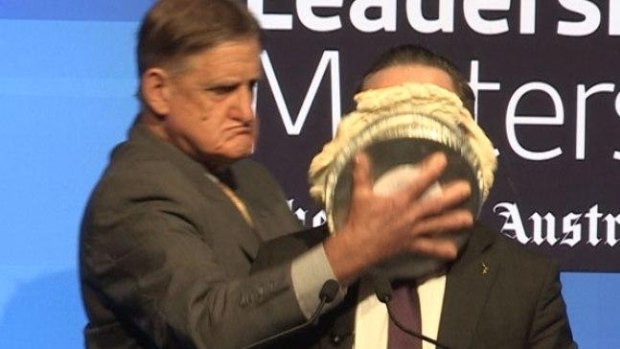 Alan Joyce hit with a pie during an event in Perth.