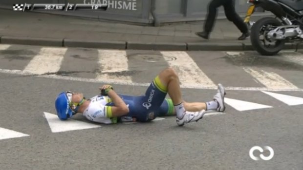 Crash, bang: Simon Gerrans lies on the road after his second accident in the Liege-Bastogne-Liege classic.