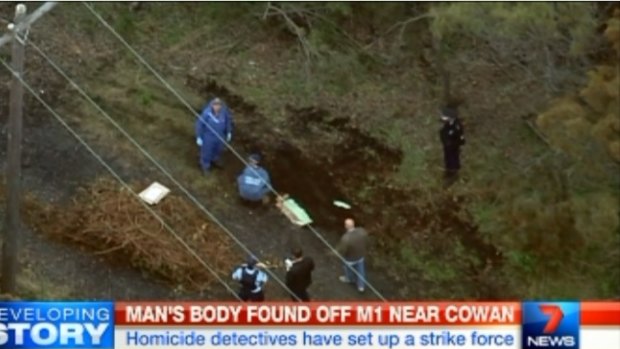 Police inspect the body near the Pacific Highway.