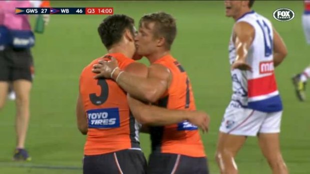 Rhys Palmer and Stephen Coniglio share the love at Manuka Oval on Thursday.