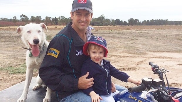 Justin Sternes, on the farm in Tara in western Queensland with his son Maverick.