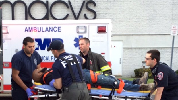 The suspect is put into an ambulance by medical personnel at the Silver City Galleria mall in Taunton.