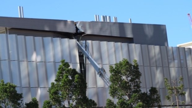 A crane rests against the Griffith University College of Art after falling at a construction site on Grey Street at South Bank.