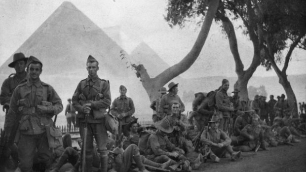 Far from home: Australian infantry resting beside the tramline near Mena, with the Giza pyramids behind them.