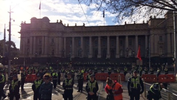 Heavy police presence at Parliament House as rival groups gather to rally.