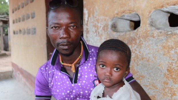 Komba Nyama, pictured with his daughter Betsy, drove Mohamed Mansaray to hospital.