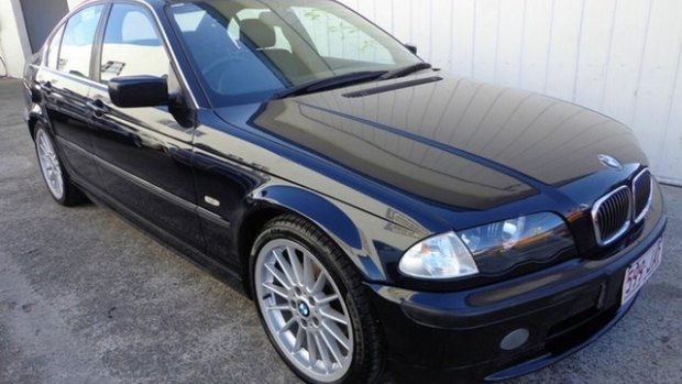 A blue 1999 BMW sedan, registration 599 JAF, that was stolen from Nerang Car City.